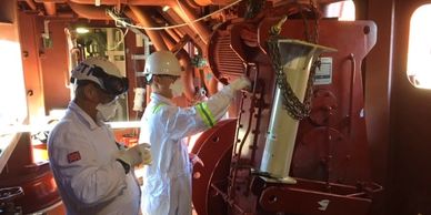 Technicians taking asbestos samples on ship