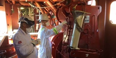 Technicians taking asbestos samples on ship