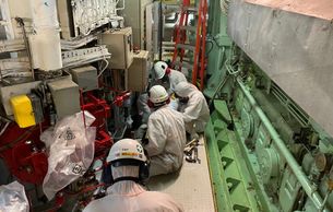 ships engine room with asbestos gaskets being removed. 