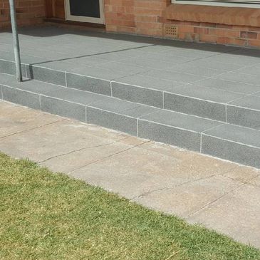 A small verandah resurfaced and given a large tile  stone look