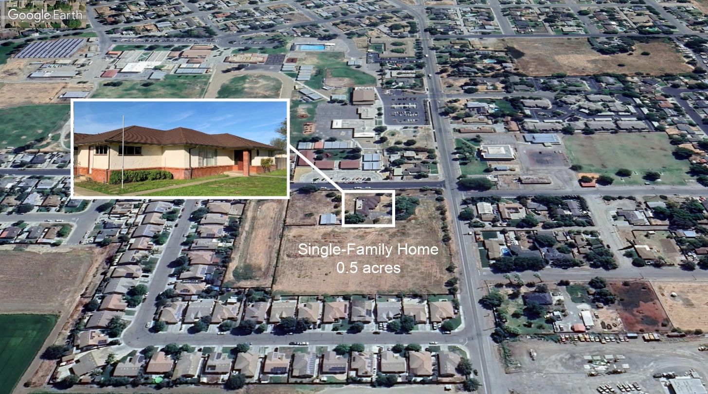 Aerial view highlighting a single-family home on 0.5 acres in a residential neighborhood.