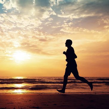 Man running on beach after he's rediscovered joy following his IV ketamine treatment