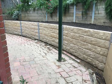 Concrete sleeper retaining wall - Cream coloured block patterned sleepers