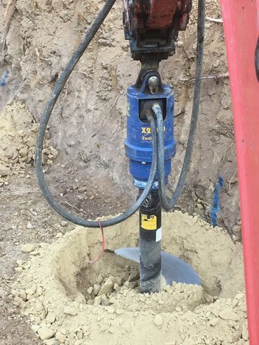 Drilling holes for a new retaining wall