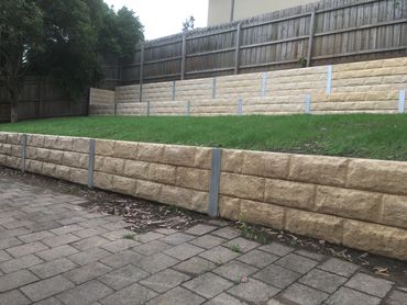 Concrete sleeper retaining wall - cream coloured block pattern
