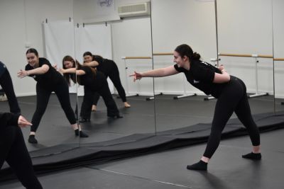 Dance class rehearsing choreography in studio.
