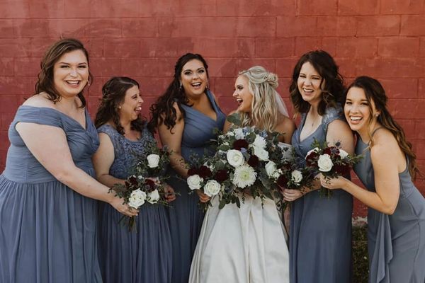 a bridal party and a bride with a dark red lip