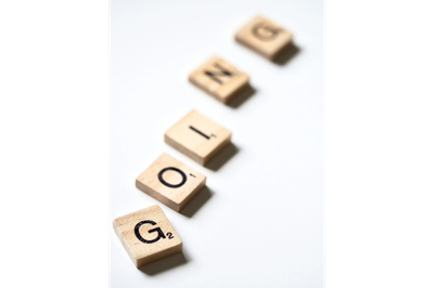 Scrabble tiles spelling the word 'GOLINE'.