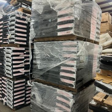 Stacks of wrapped pallets with boxed goods in a warehouse.