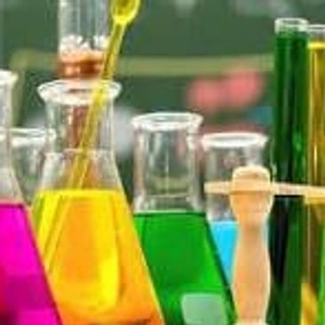 Laboratory solutions of dyes in beakers