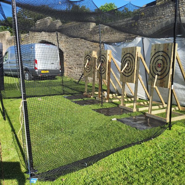 TBV AxeMasters outdoor axe throwing setup with safety netting, mobile Viking-themed event entertainm