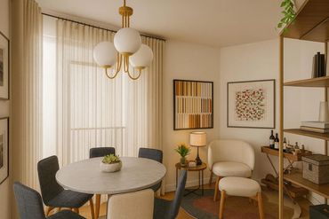 Cozy dining area with round table and modern chairs in warm lighting.
