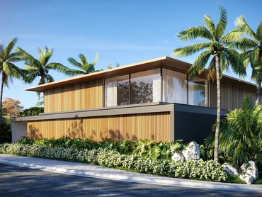 Modern house with wooden paneling surrounded by palm trees and greenery.