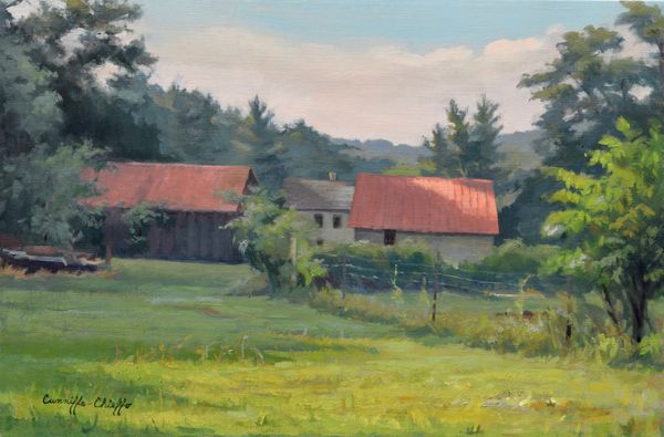 Rustic houses with red roofs in a countryside setting.