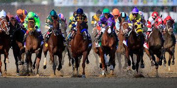 Horse race with jockeys in colorful uniforms.