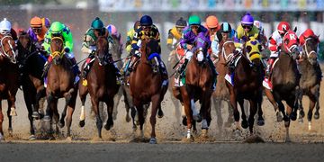 Horse race with jockeys in colorful uniforms.