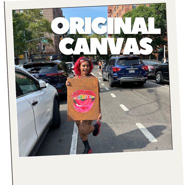 Person holding a vibrant lip art canvas in the street.