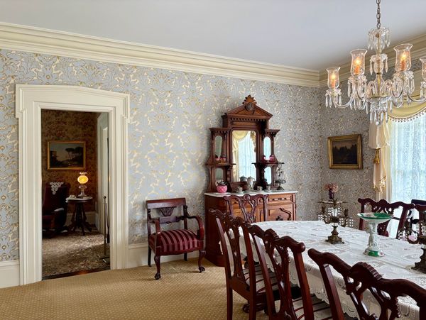 Dining room with Wheatlands Volute historic wallpaper