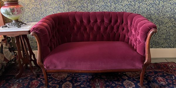 A victorian style burgundy velvet settee 
