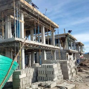 Construction site with building framework and stacked bricks.