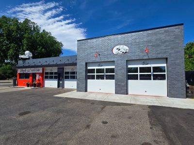 Modern fire station with garage bays under a clear blue sky.