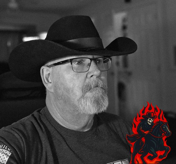 Man wearing a cowboy hat and glasses in a black and white photo.