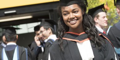 young black girl wearing graduation cap and gown