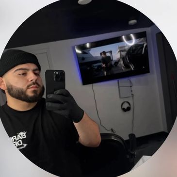 Man taking a selfie in a barbershop.