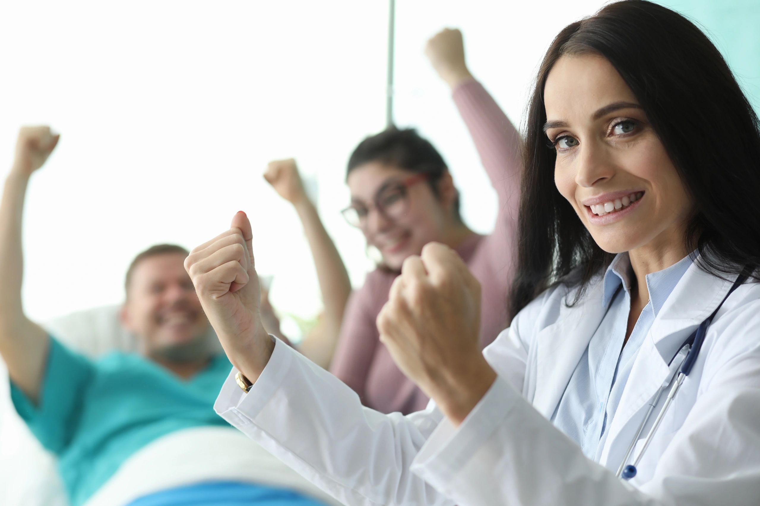 Nurses holding fists up with patient