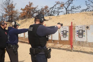 Police officers practicing shooting at a firing range.