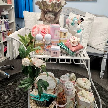 Beauty and self-care products arranged on a white metal trolley.