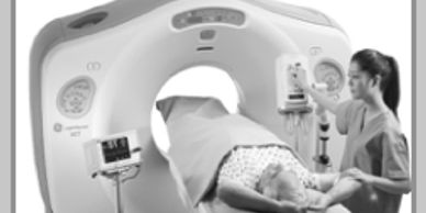 Patient undergoing a CT scan with medical staff assistance.