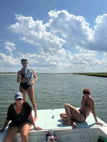 Ladies enjoy a scenic boat tour near Wrightsville Beach NC with guests enjoying a coastal adventure