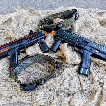 Two toy guns and two headbands with sensors on a netted fabric.