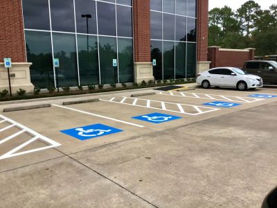 Empty handicap parking spaces near a building.