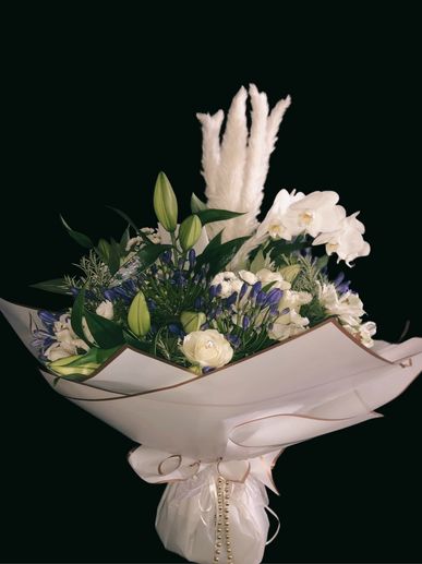Large bouquet of white flowers including pampas grass