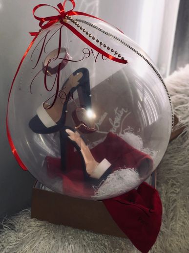 Stuffing balloon with shoes hanging inside 