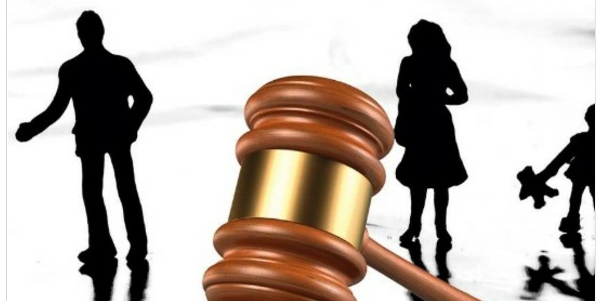 Judge's gavel with silhouettes of family members in the background.