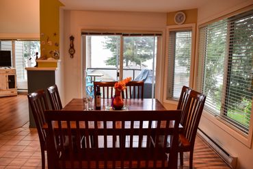 Diningroom as seen from front entrance hallway with entrance to lower deck in the background