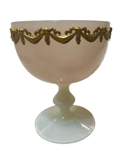Elegant white glass goblet with gold decorative trim around the rim.