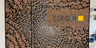 Artistic wooden block wall with the word 'COREAN' and a yellow square.