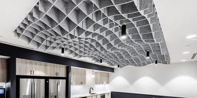 Modern kitchen with a unique textured ceiling design and sleek appliances.