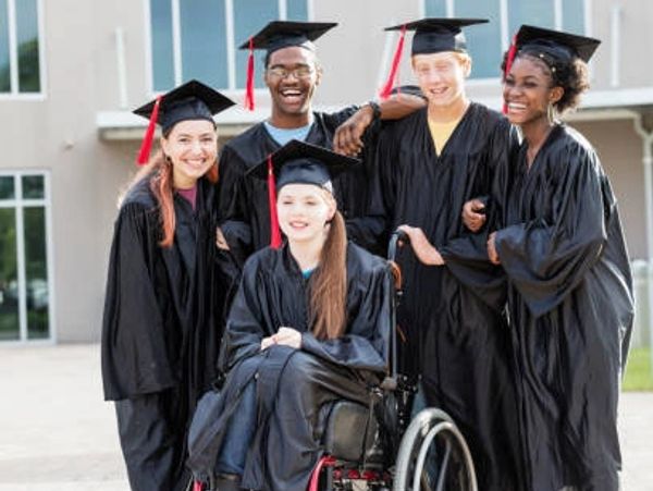 Diverse group of graduates in caps and gowns celebrating together.