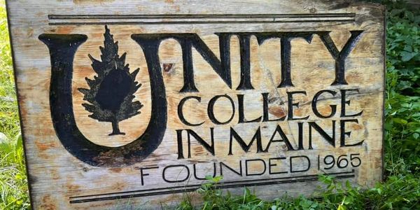 Original hand-carved wooden sign of Unity College in Maine, founded in 1965 in Unity, Maine.