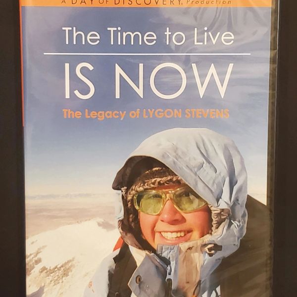 DVD cover of "The Time to Live Is Now" featuring a smiling person in winter gear.
