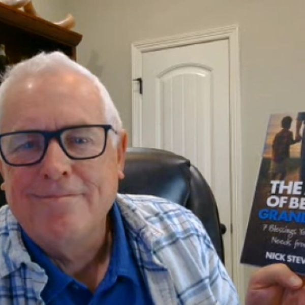 Man holding a book titled 'The Art of Being Granddad' by Nick Stevens.