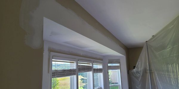 Window area under renovation with fresh paint patches.