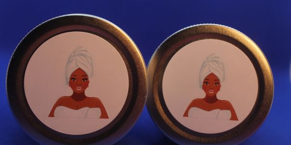 Two cosmetic containers with labels showing a woman wrapped in a towel and turban.