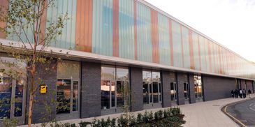 Modern building with colorful glass panels and large windows.
