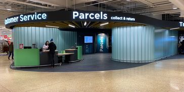 A modern parcel collection and customer service area inside a store.